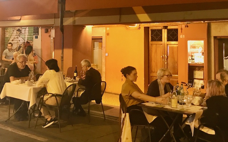 People sitting at outside tables at Caminetto d'Oro - Bologna Food Tour