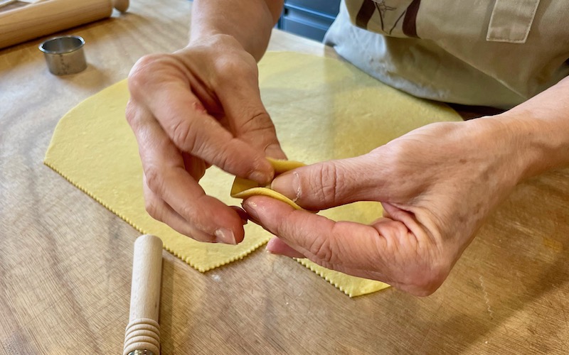 Casa Artusi Pasta Making close-up folding tortellino - Food & Wine Tour Emilia-Romagna