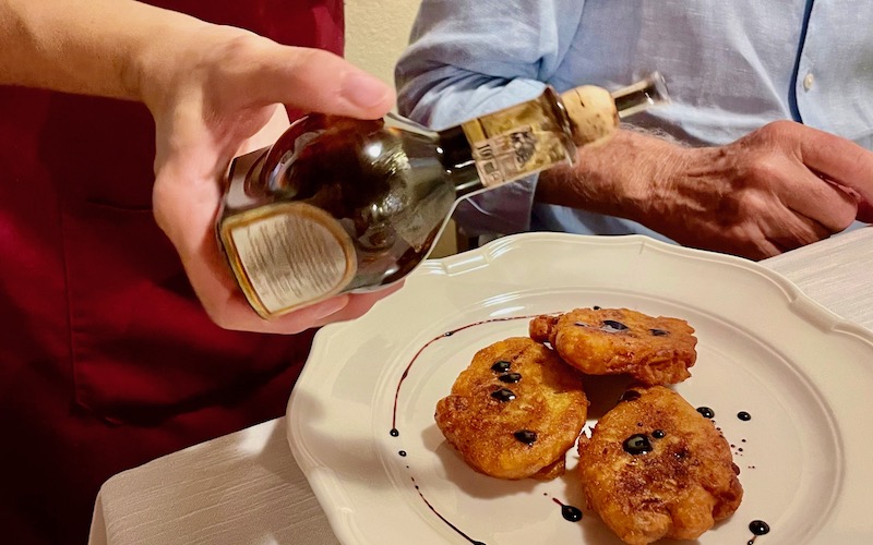Hosteria Giusti balsamic vinegar drizzled on fritters - Modena Food Tour