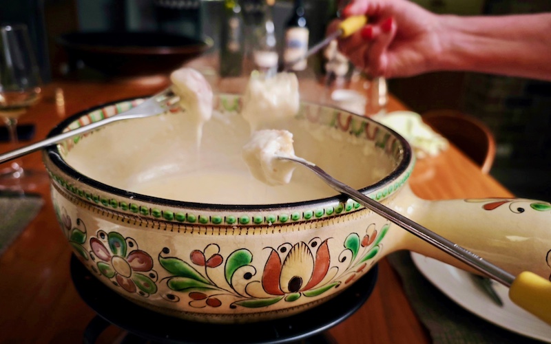 Cheese Fondue - 3 pieces of bread above the caquelon (fondue pot)