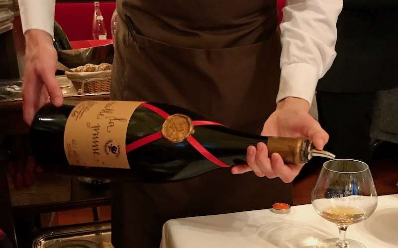 Digestif being poured from a double magnum at Bistro Allard, one of the Best Bistros in Paris