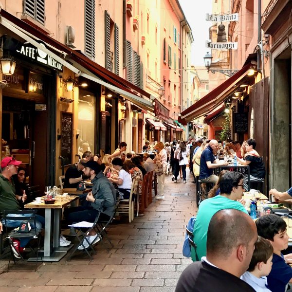 People eating outside shops in Quadrilatero Food Market Bologna - Italian Food & Wine Tour