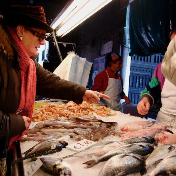 Rialto Market, local woman pointing at seafood - Venice Food & Wine Tour